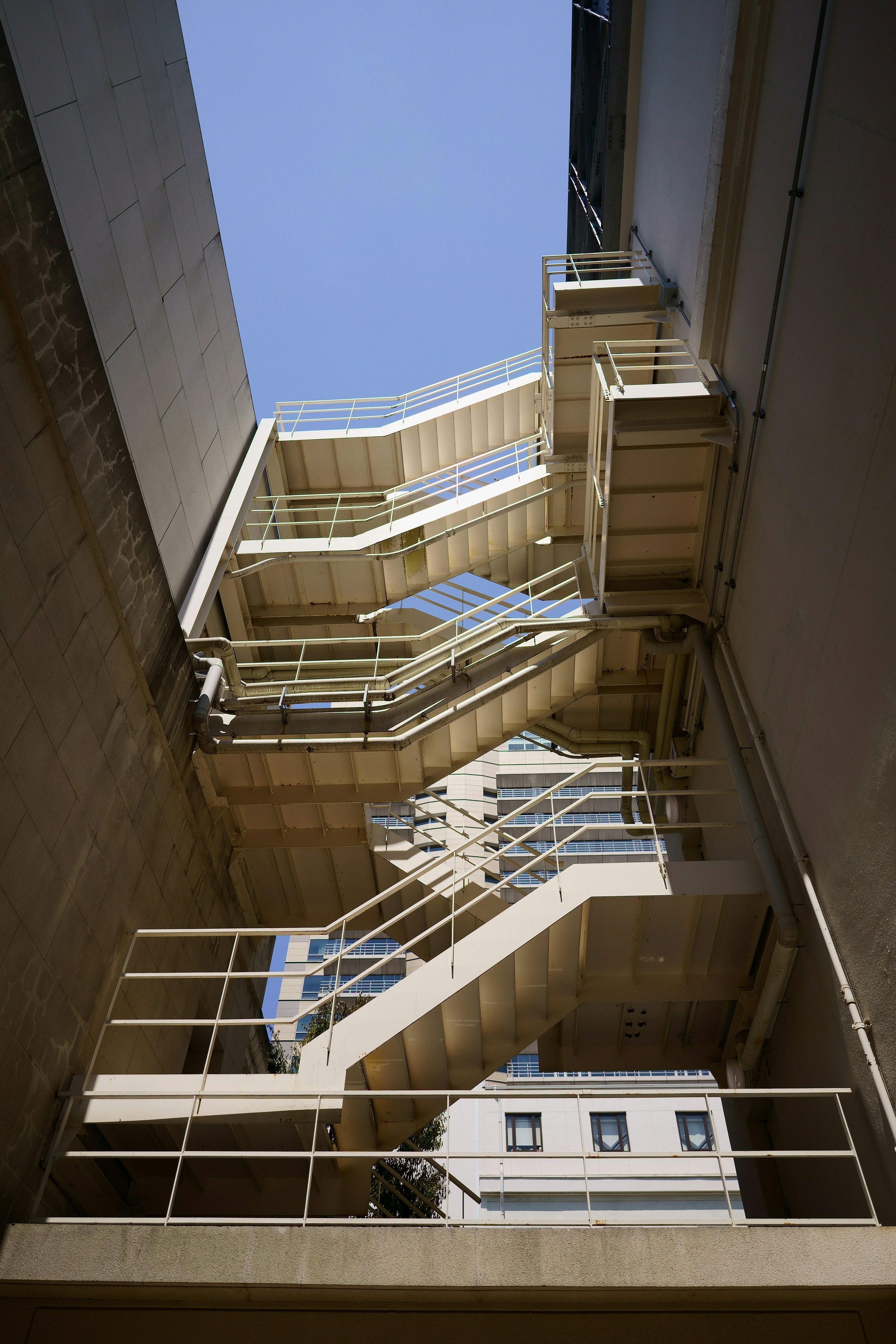 looking up at a tall building with balconies