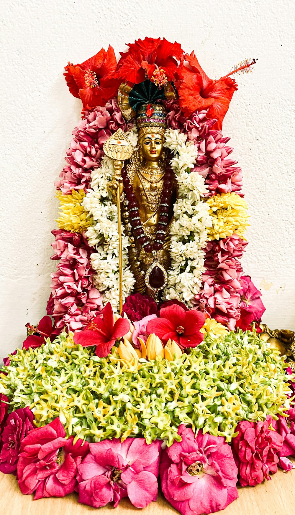 a statue of a person surrounded by flowers
