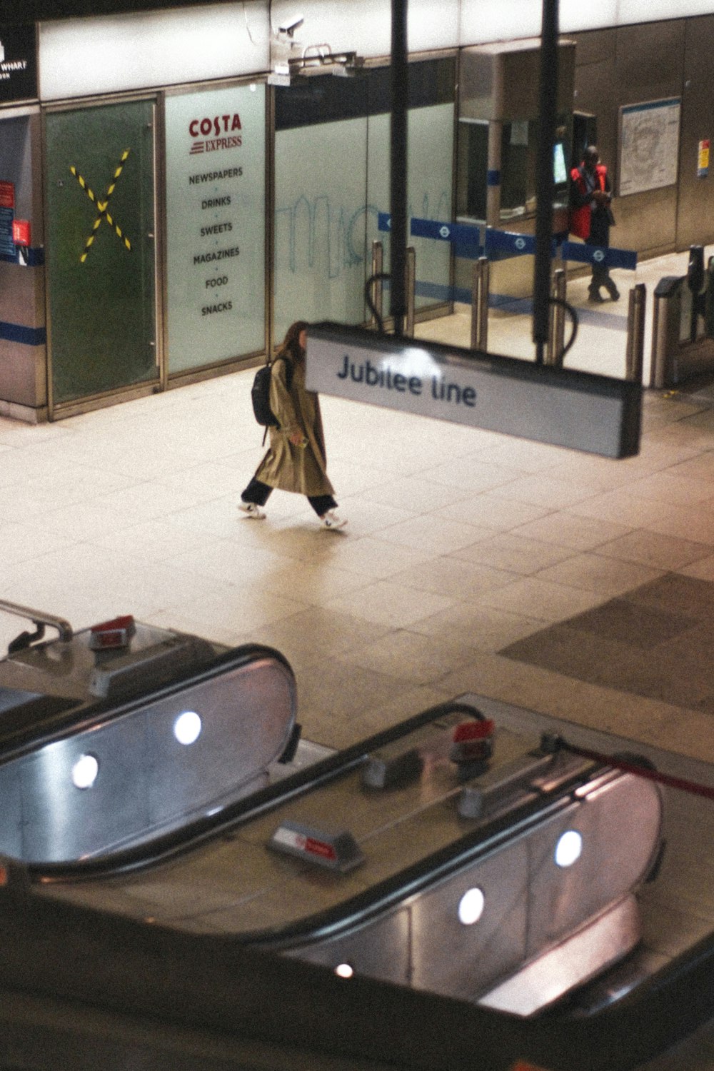 a woman is walking through an airport terminal