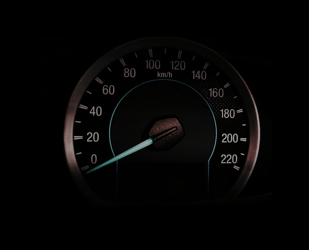 a close up of a speedometer in the dark