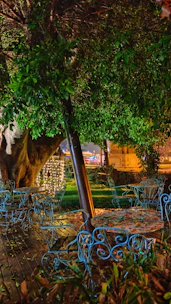 Outdoor patio with stylish navy blue furniture and subtle golden decorative lights.