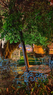 Outdoor patio with stylish navy blue furniture and subtle golden decorative lights.