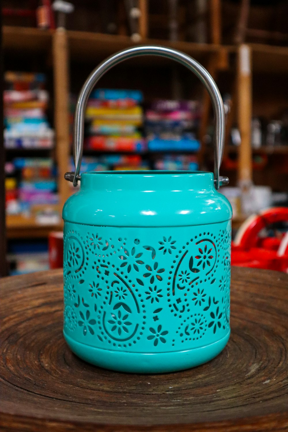 a teal canister sitting on top of a wooden table