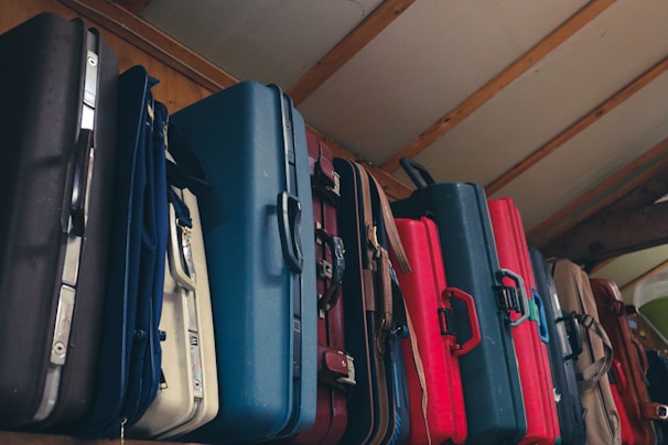 A stylish selection of durable suitcases in various colors displayed on a store shelf.