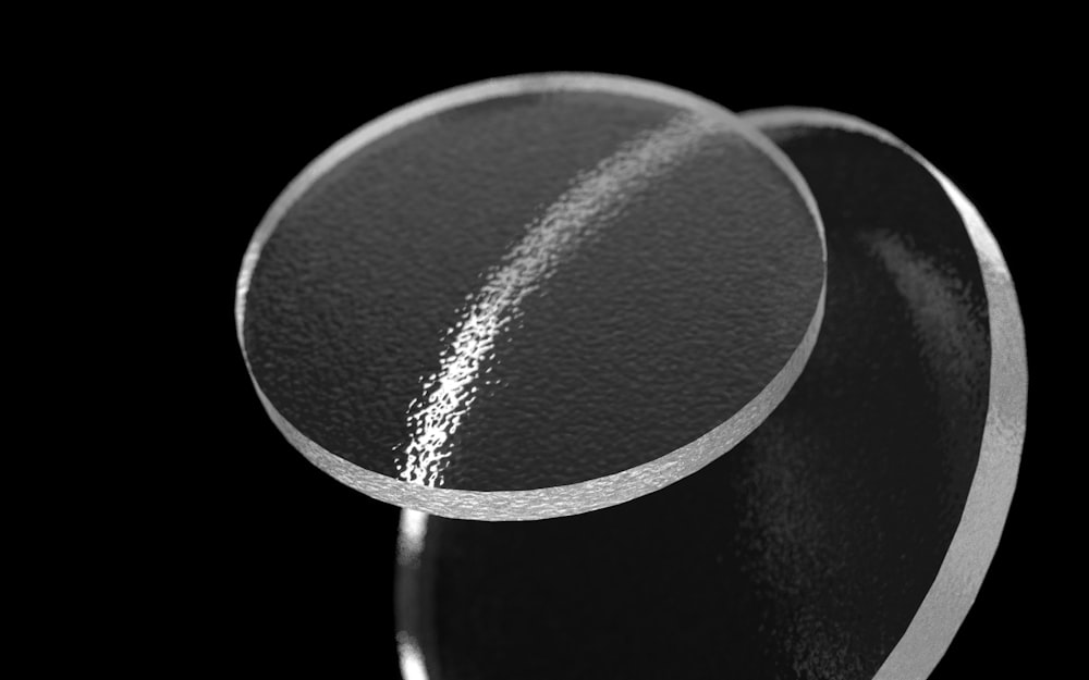 a close up of a metal object on a black background