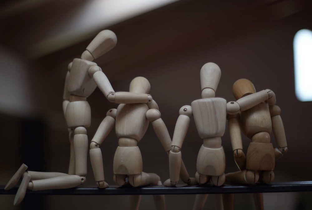 a group of wooden figures standing on top of a table