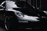 a black porsche parked on the side of the road