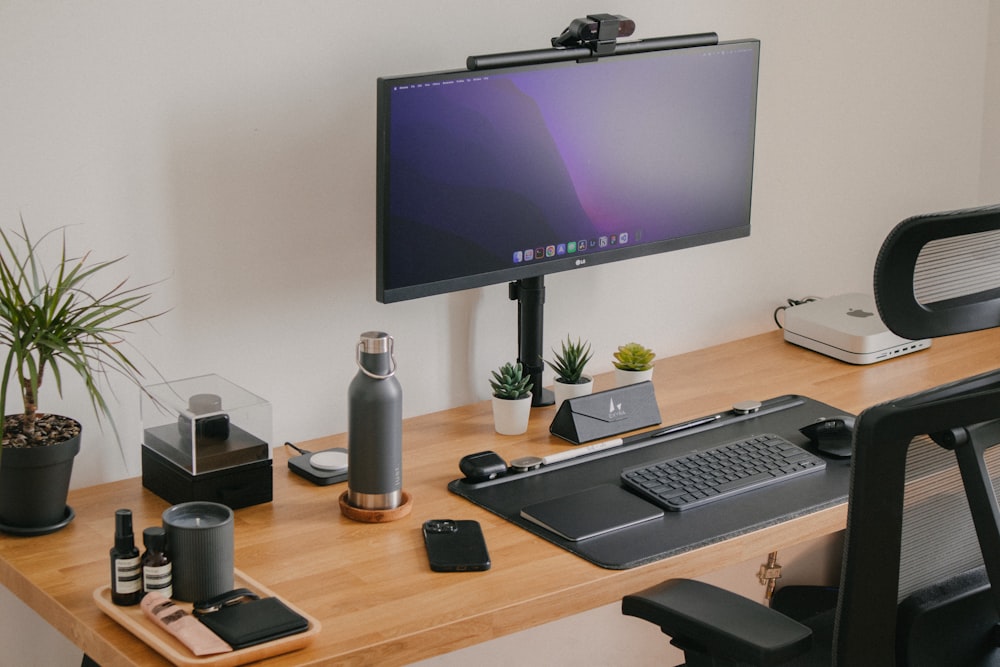 a computer monitor sitting on top of a wooden desk