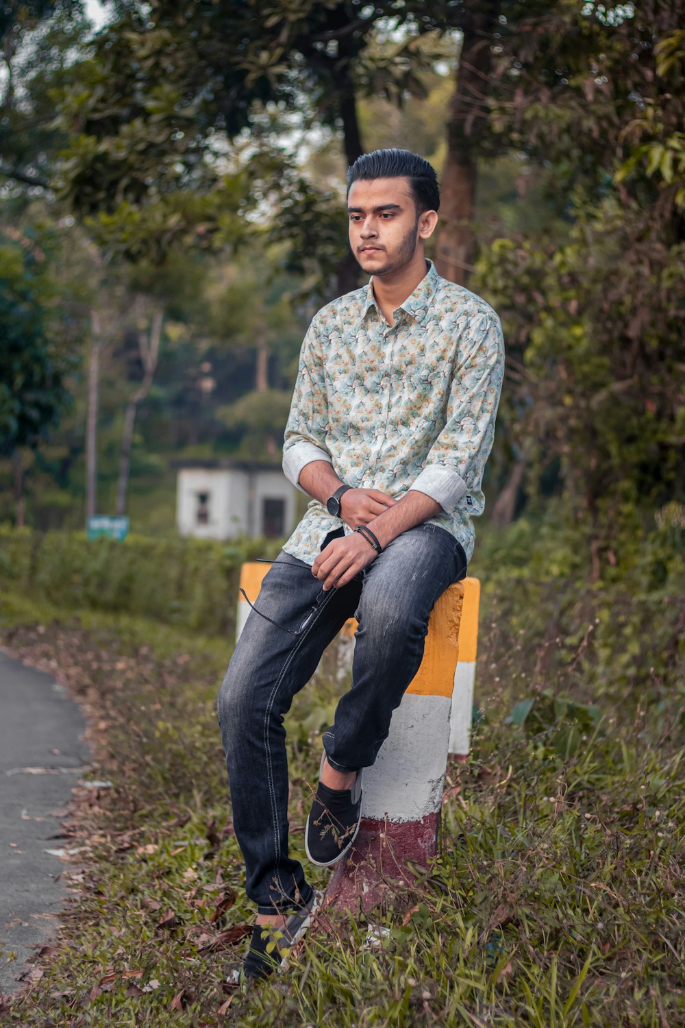 a man sitting on top of a yellow and white sign