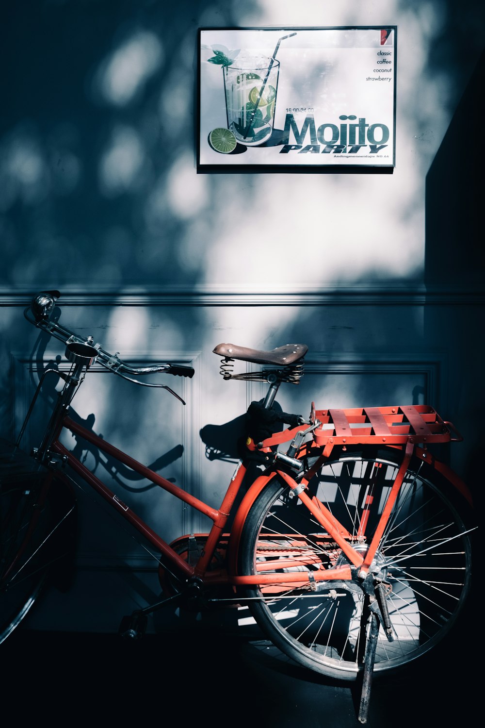 a red bicycle parked in front of a sign