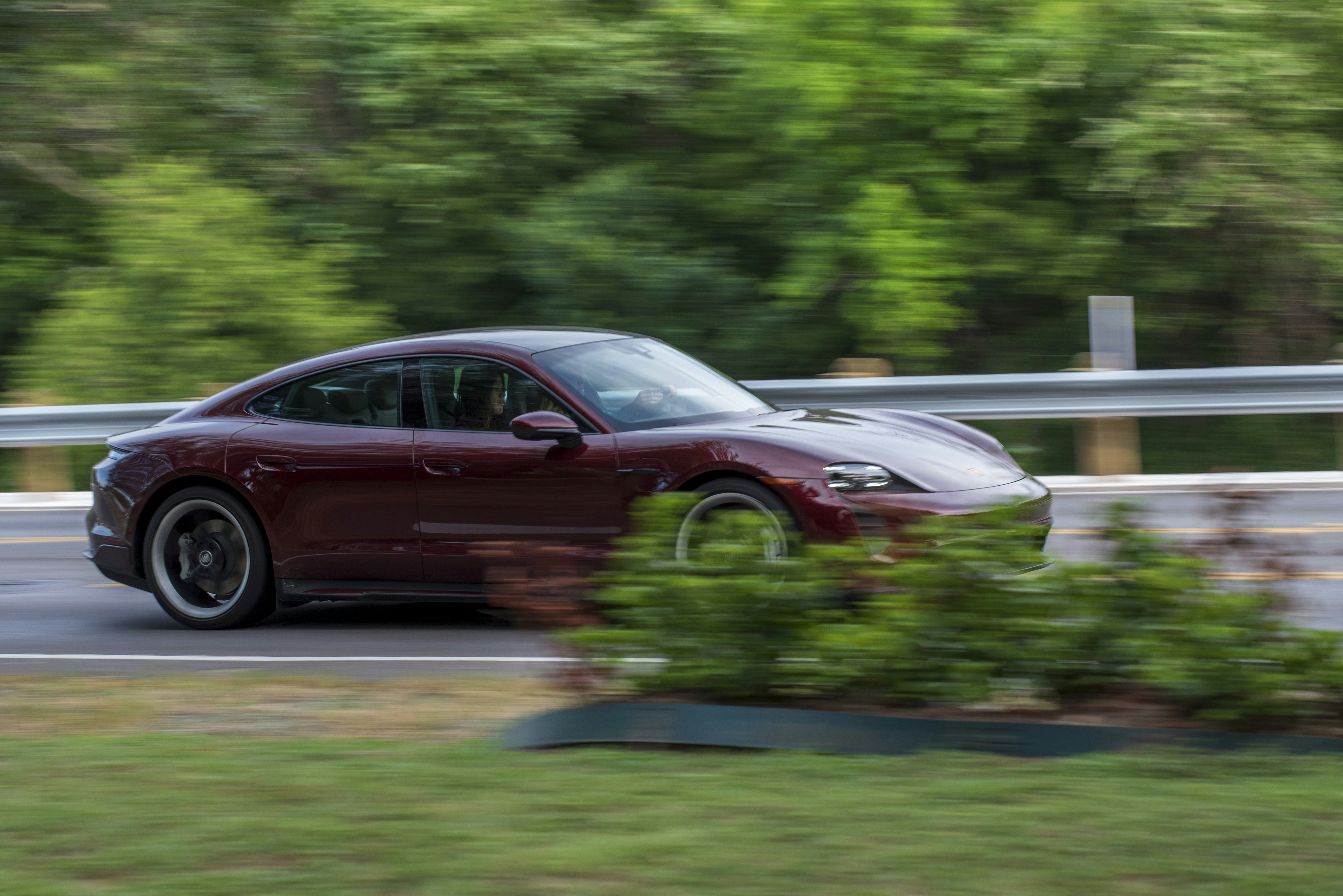 Purple Porsche Taycan Turbo S electric sports car on modern highway