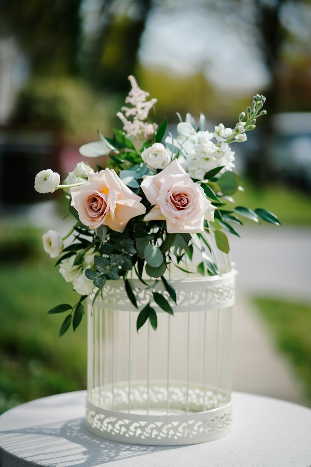 a white vase filled with flowers on top of a table