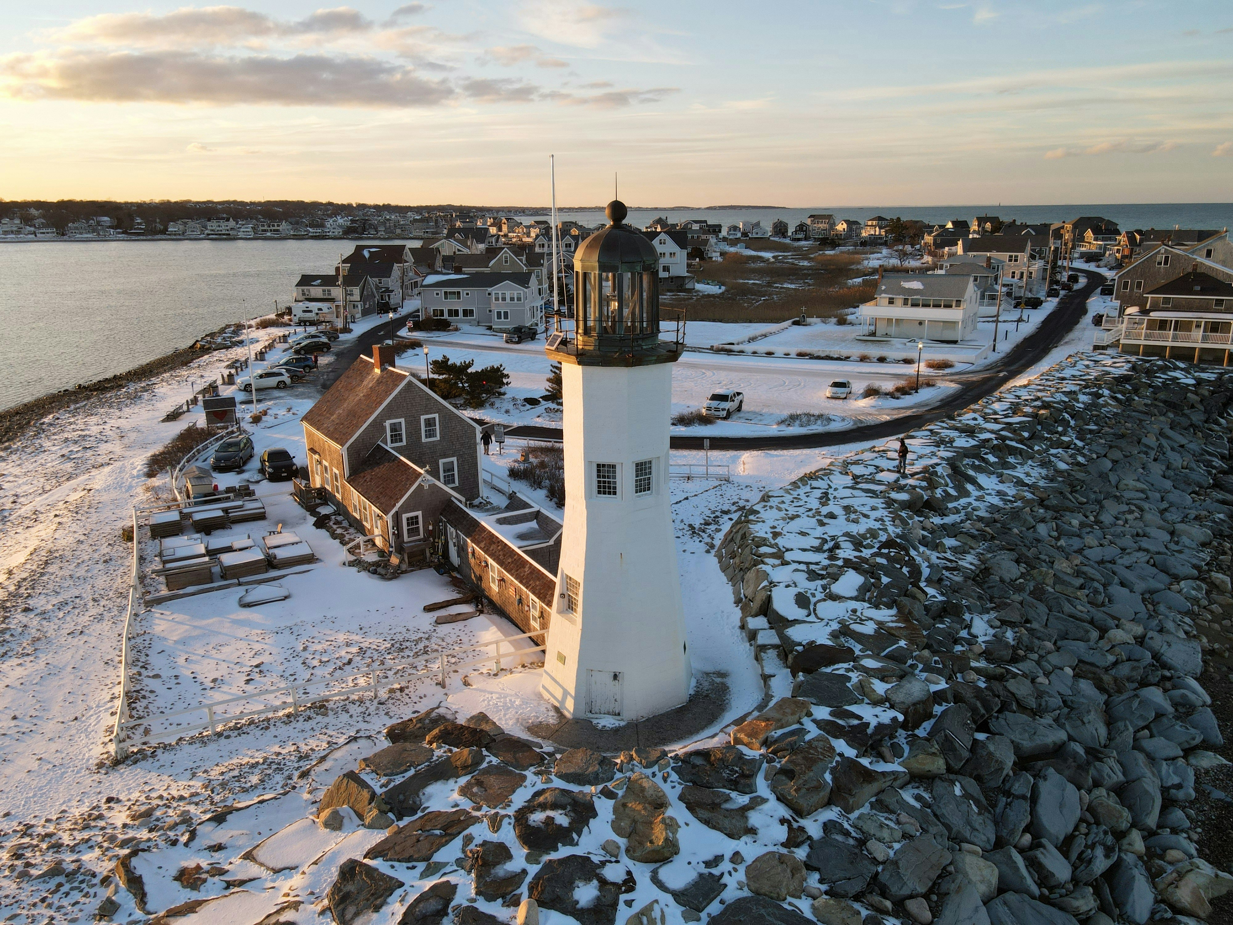 a light house sitting on top of a snow covered beach