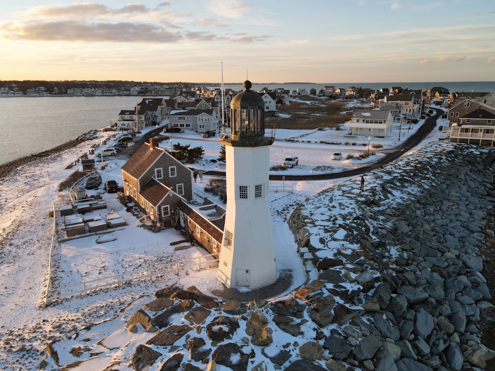 a light house sitting on top of a snow covered beach