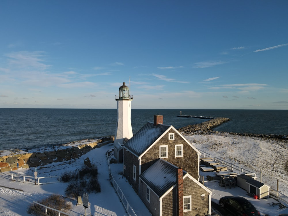 a light house sitting on top of a snow covered beach