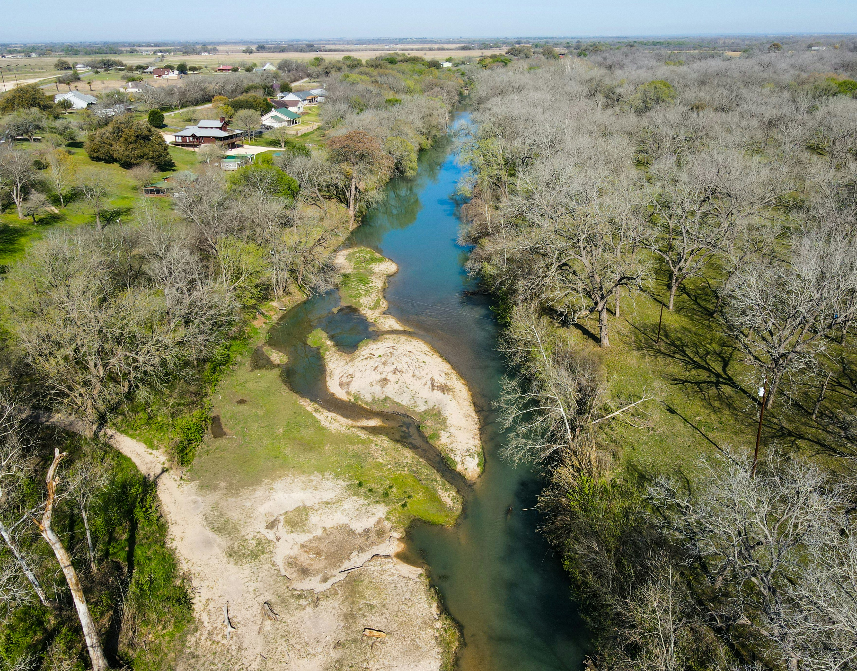 a river running through a lush green forest