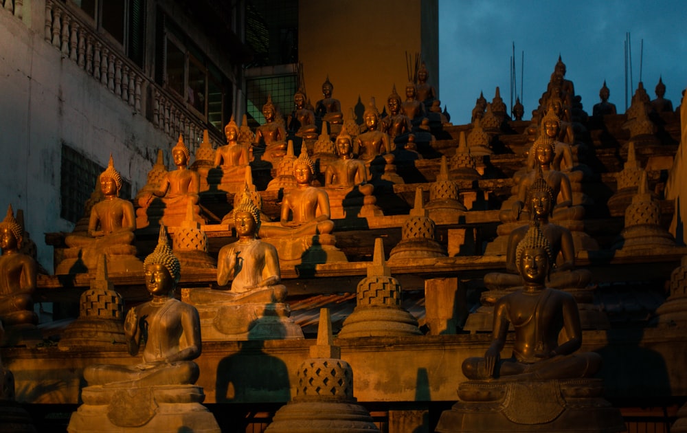 a group of buddha statues sitting next to each other