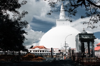 a large white dome with a clock on top of it