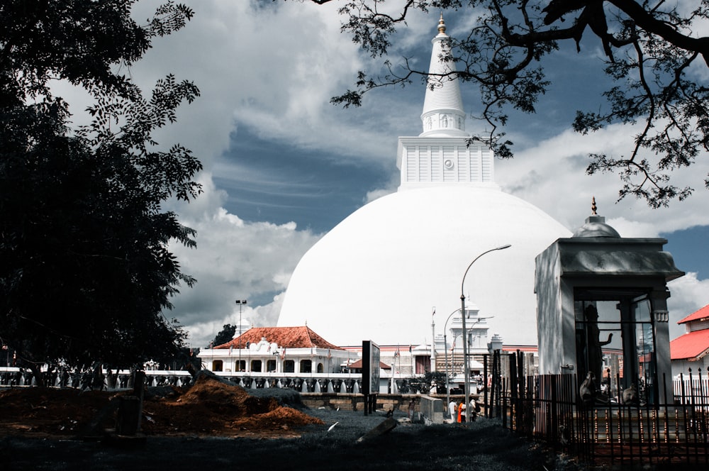 a large white dome with a clock on top of it