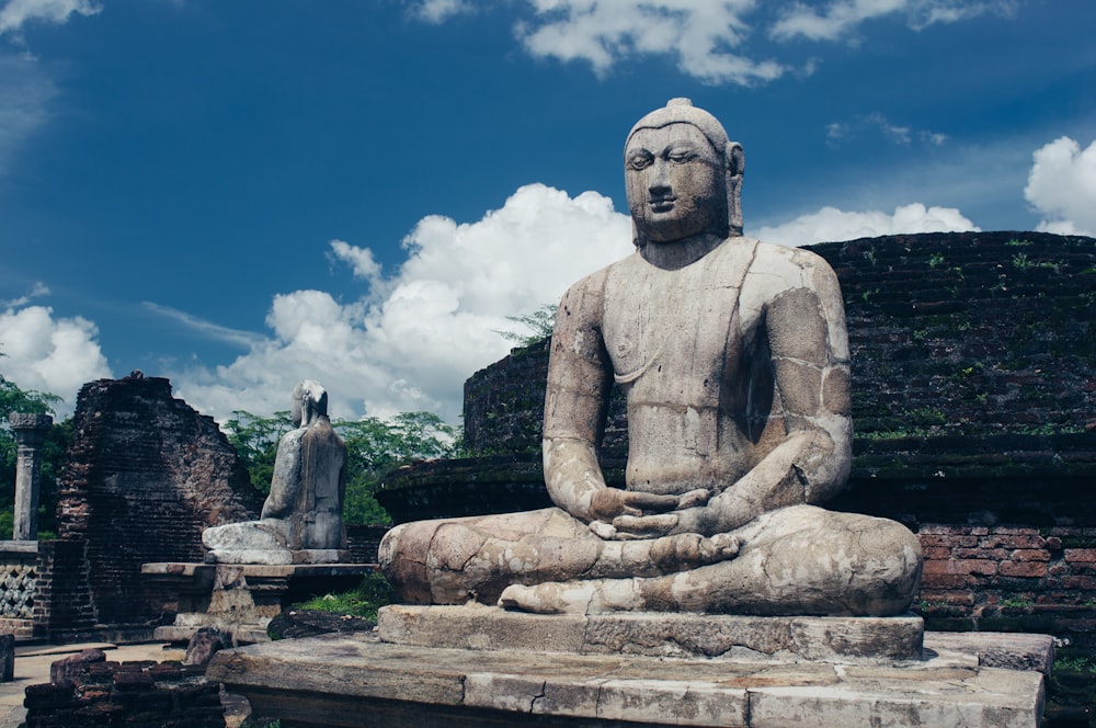 a statue of a person sitting in a meditation position