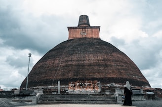a person standing in front of a large building