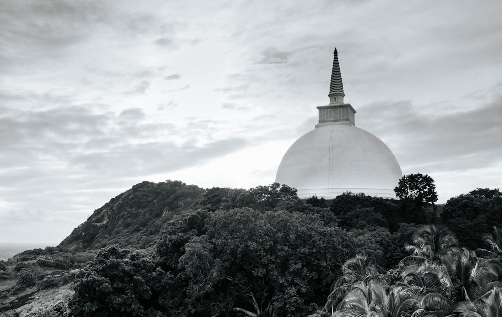 a black and white photo of a building on top of a hill