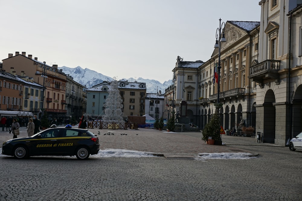 a police car parked on a cobblestone street