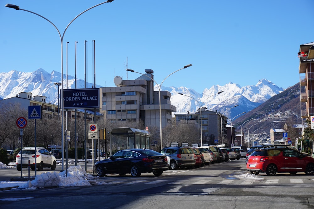 a city street filled with lots of traffic next to tall buildings