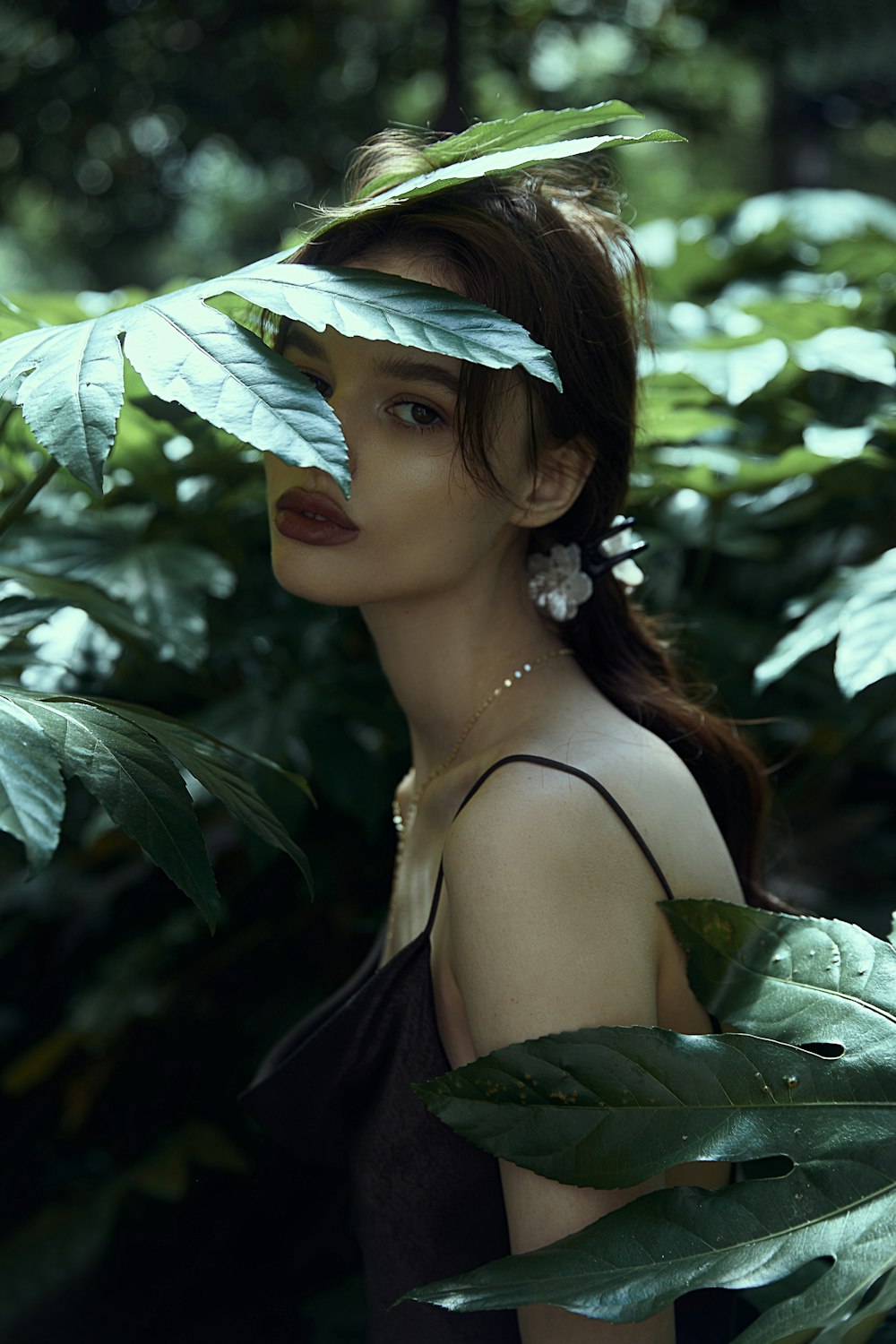 a woman with a leaf on her head