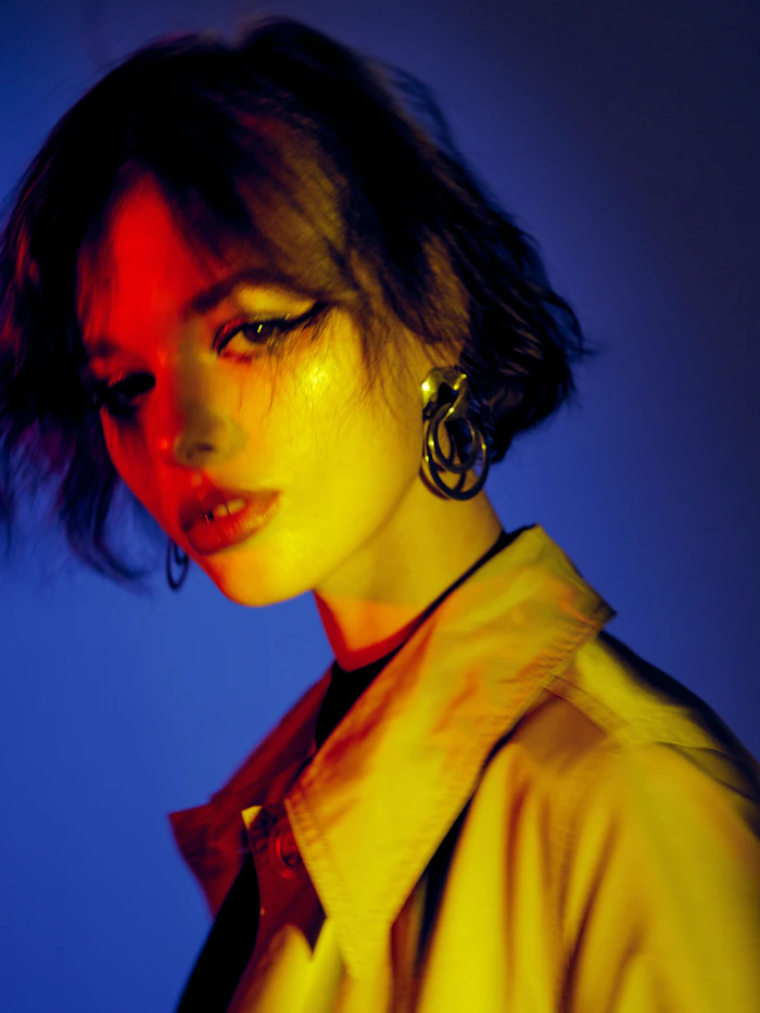 Model in a yellow top with vintage earrings, soft editorial light