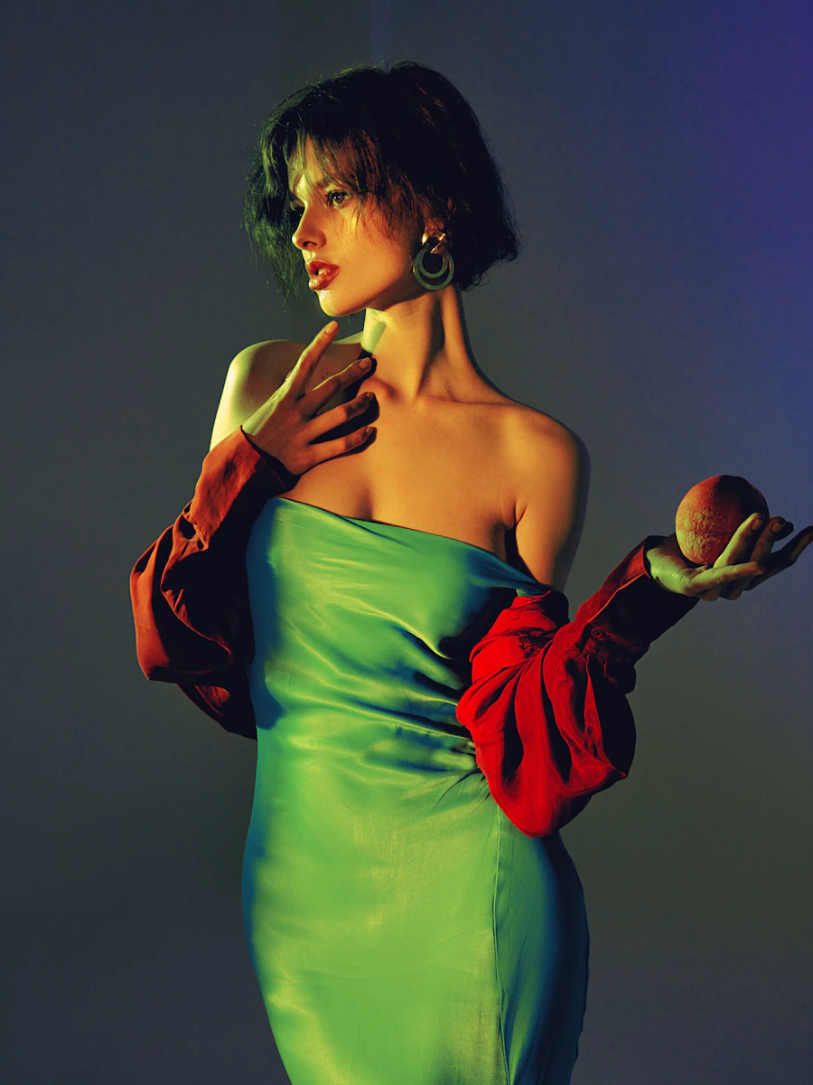 Woman in a green dress holding an apple