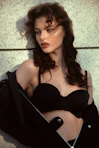 a woman in a black bra posing for a picture