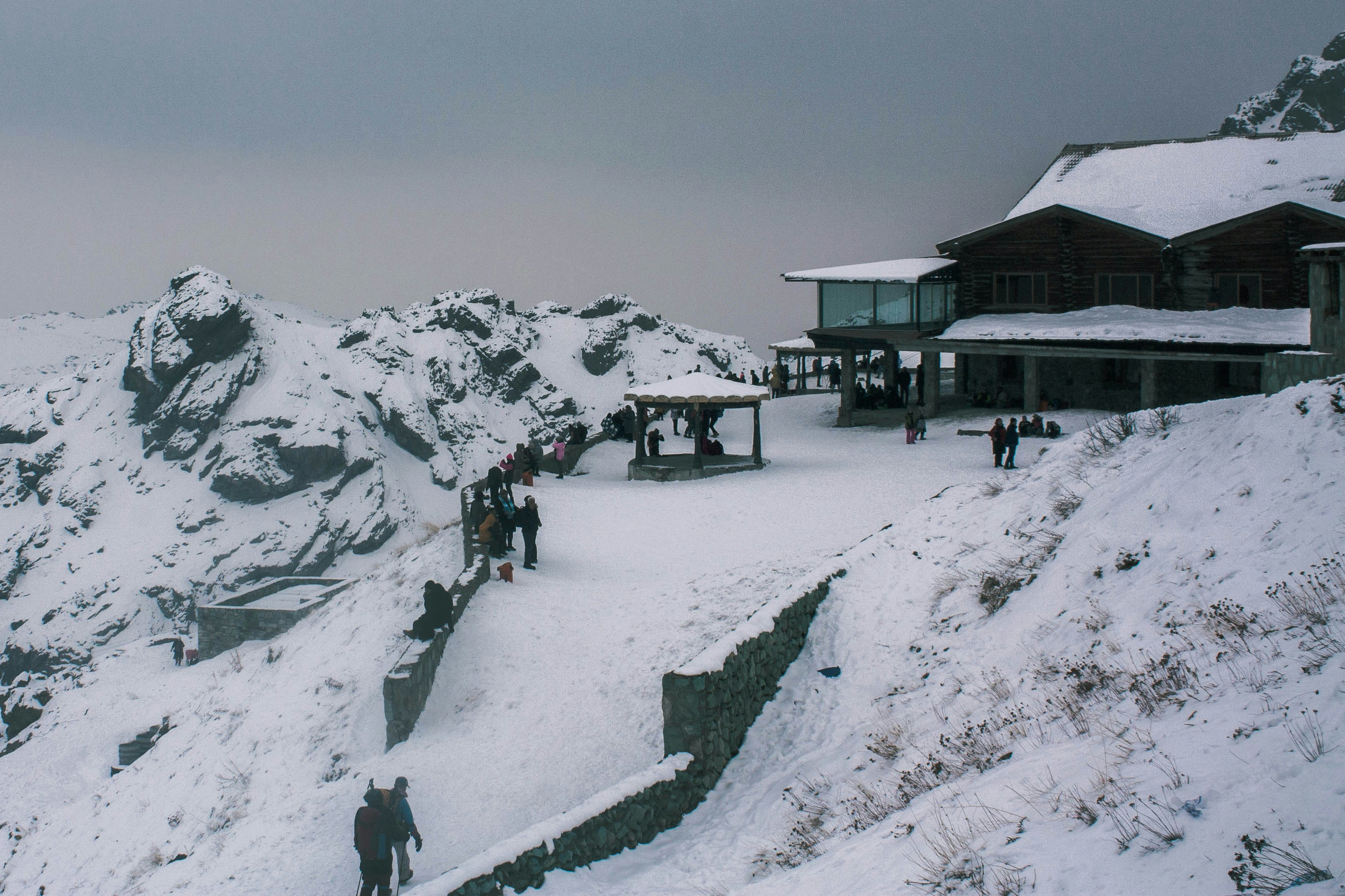a group of people standing on top of a snow covered mountain