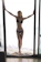 A happy woman wearing a sleek, modern shapewear in a softly lit room.