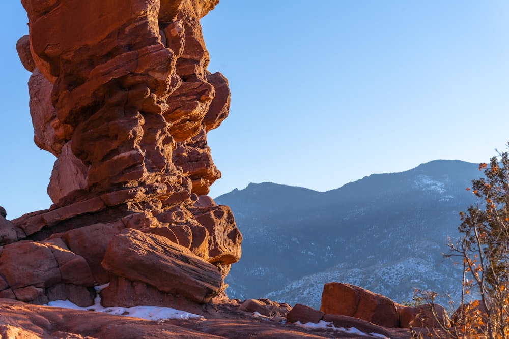 a rock formation with a mountain in the background