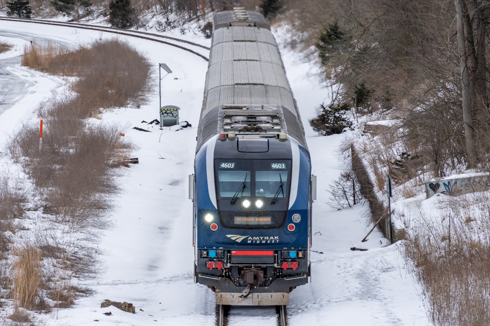 a train traveling through a snow covered countryside