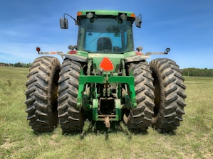 A high-quality Valtra BM 110 4x4 tractor in a field.