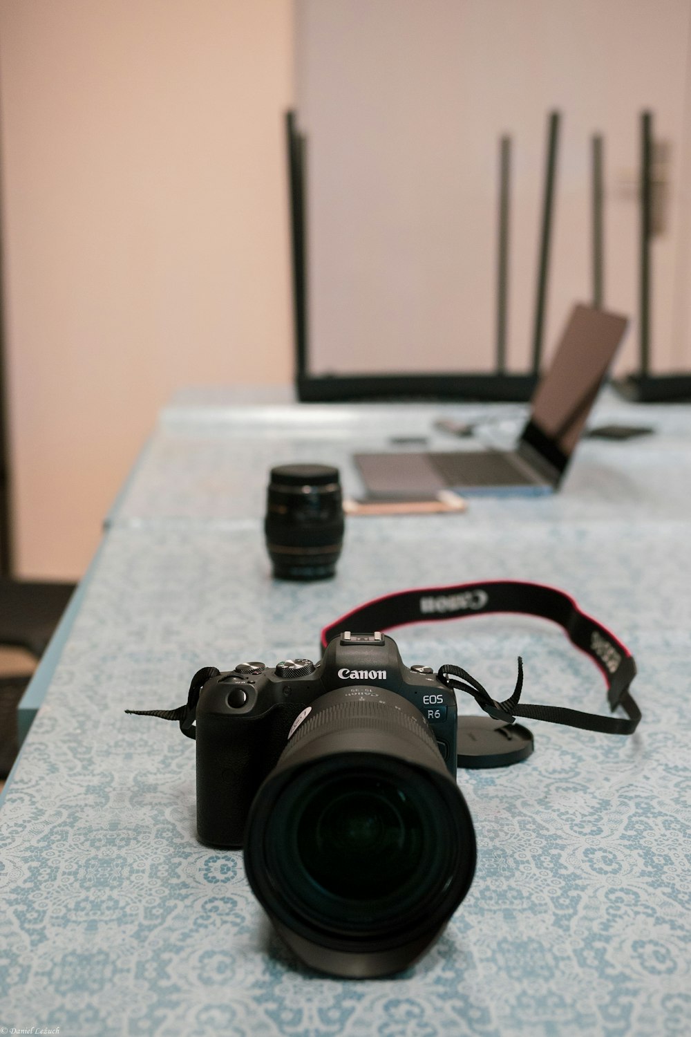 a camera sitting on top of a table next to a laptop