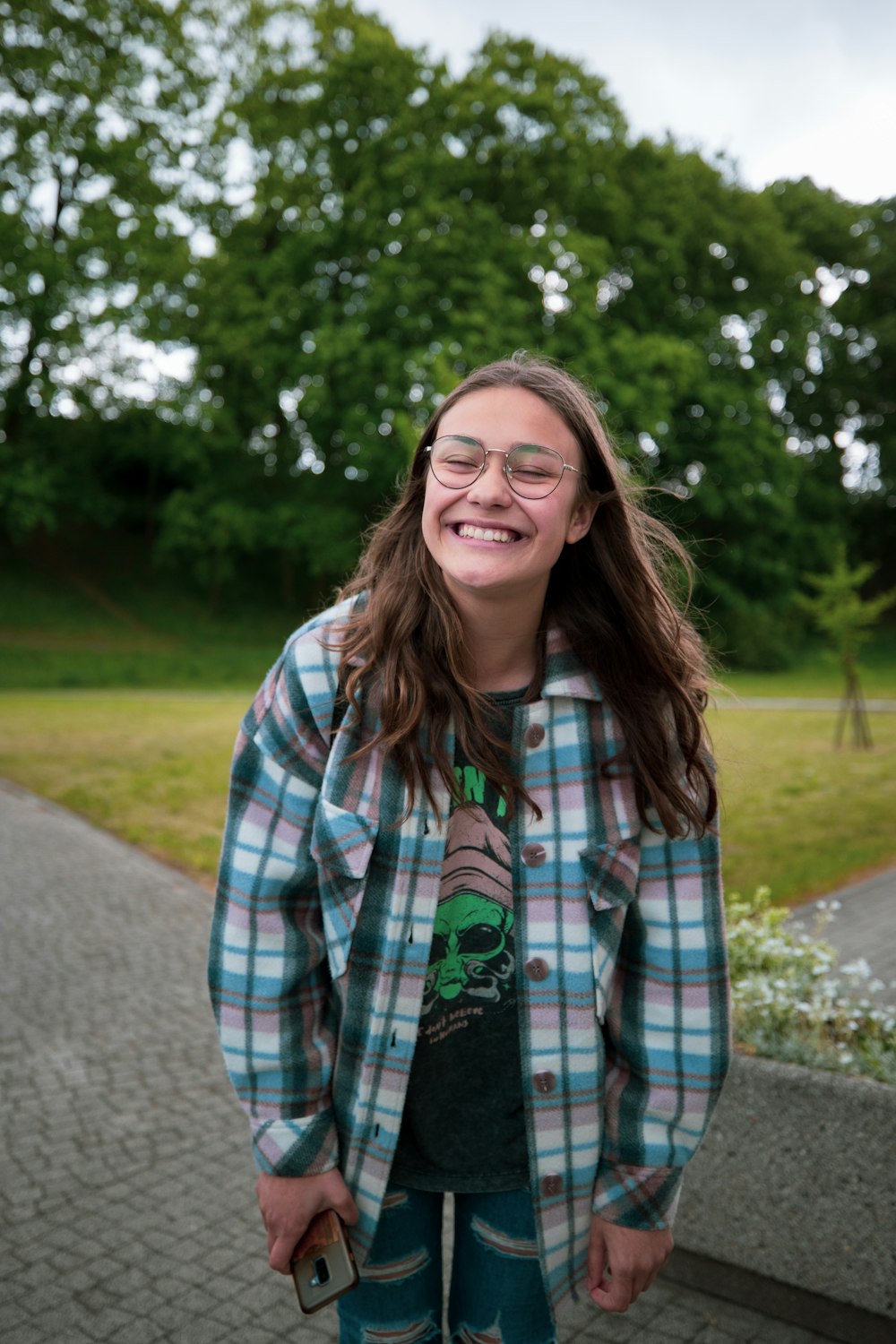 a young girl wearing glasses and a plaid shirt