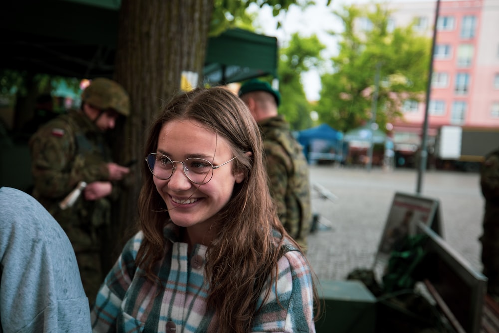 a woman wearing glasses and a plaid shirt