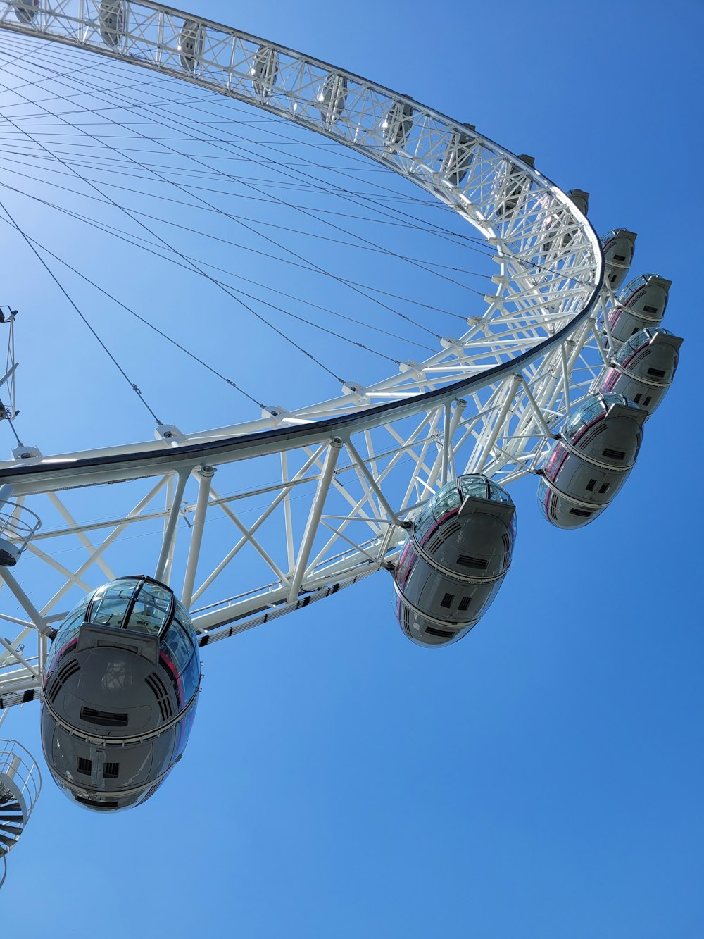 a large white ferris wheel against a blue sky