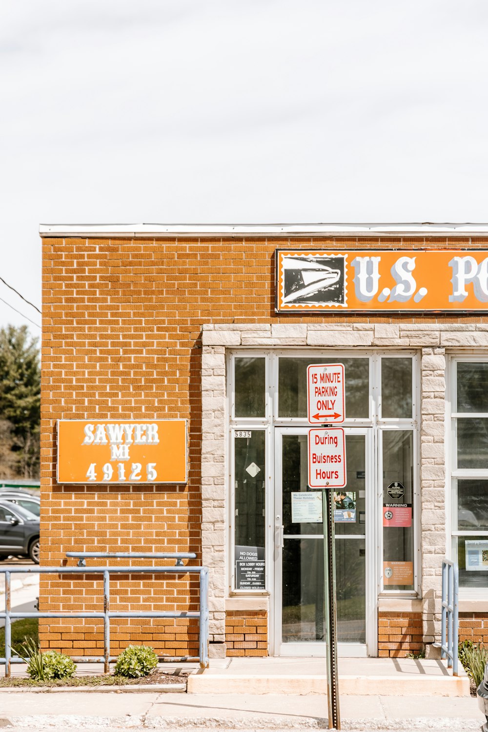 a brick building with a sign that says u s post