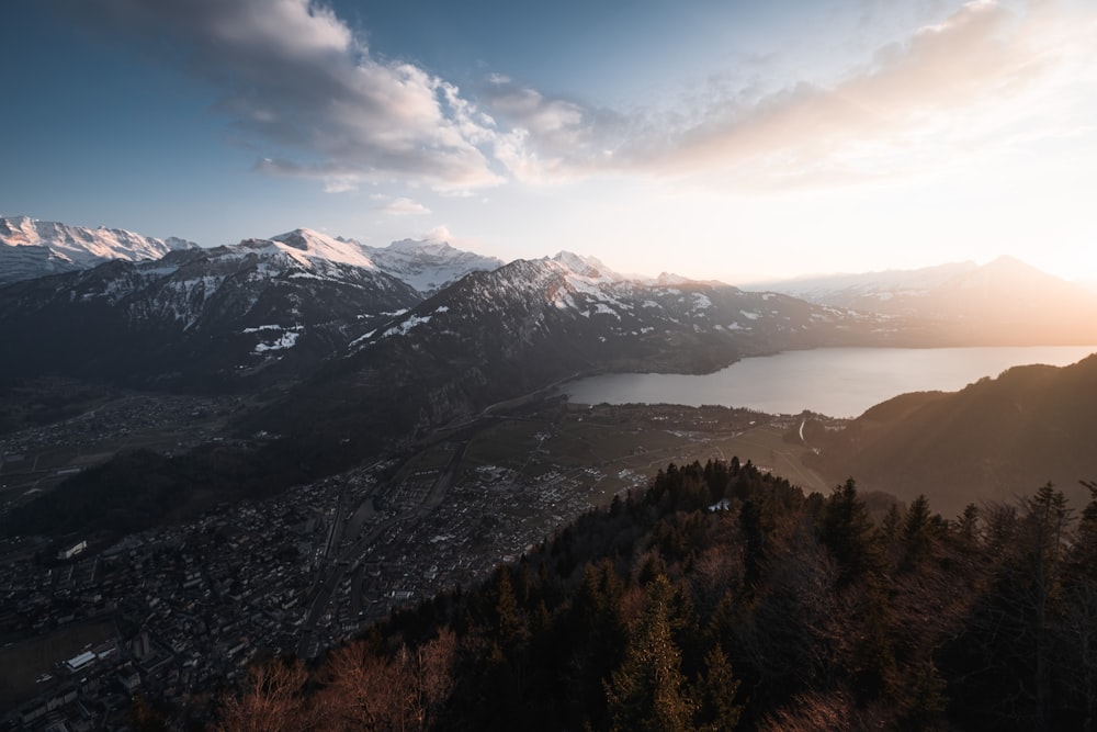 a view of a mountain range with a lake in the foreground