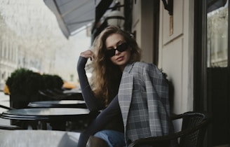 a woman sitting in front of a building