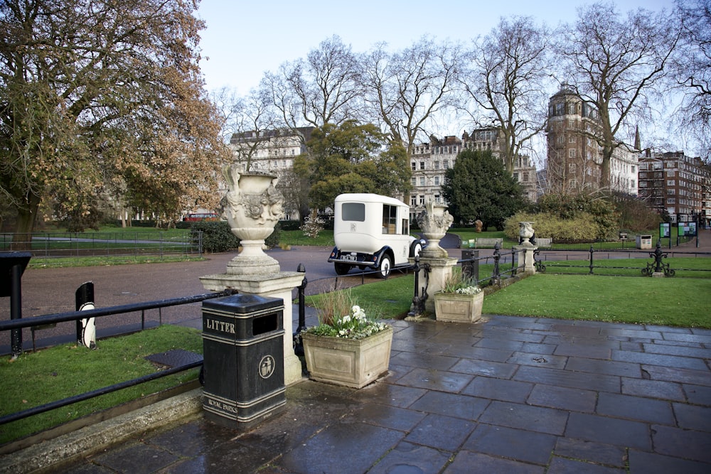 a white truck parked in front of a park