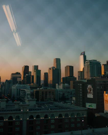 View from hotel window showing city skyline at dusk.