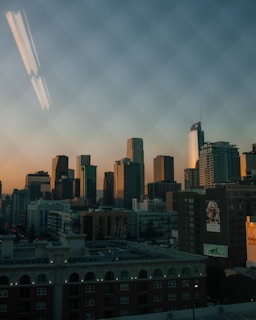 Elegant high-rise penthouse with city skyline at dusk.