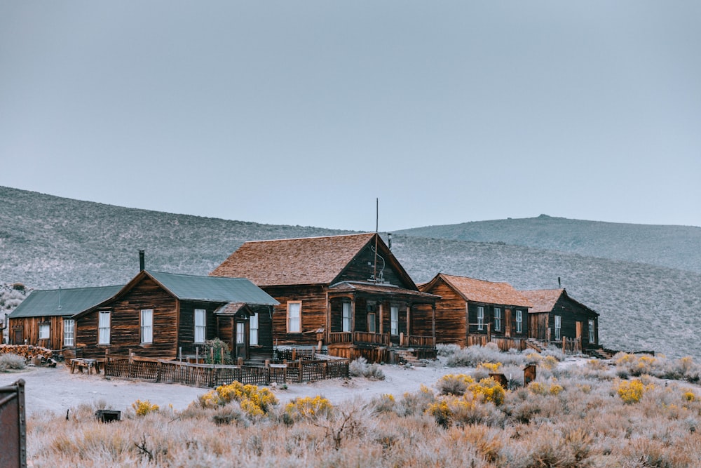 a wooden house in the middle of a field