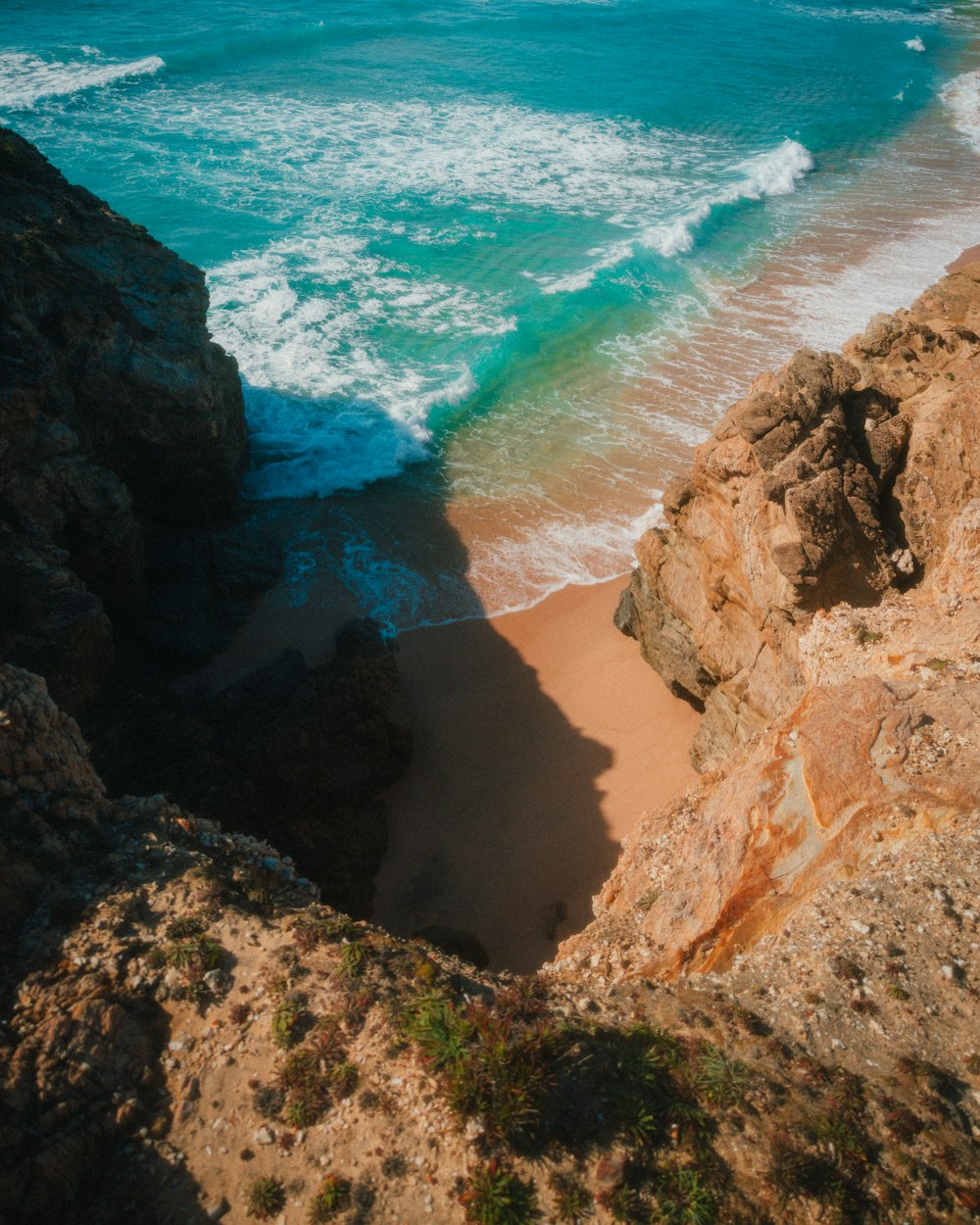 a view of the ocean from a rocky cliff