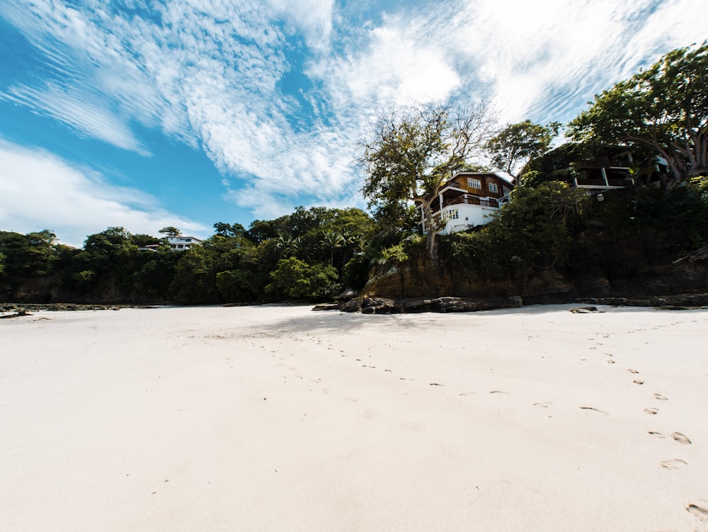 a sandy beach with a house on top of it